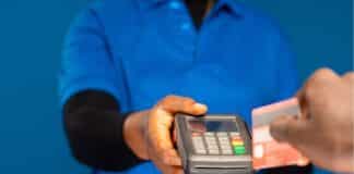 Person swiping their credit card on a mobile point of sale device
