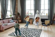 Three happy kids playing catch-up in living-room