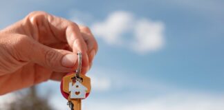 10 Strategies to Increase Bookings for Your Rental Property Person holding house keys