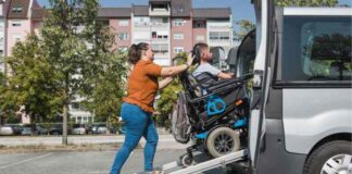 How Non-Emergency Medical Transportation Helps the Elderly and Disabled female assistant helping man