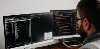 Simple Checks to Avoid Costly Cloud Failures Man Working on Computers Coding