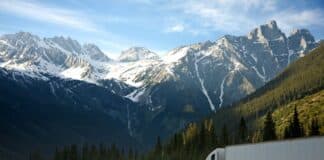 What Fleet Managers Should Know Before Ordering Heavy Duty Truck Parts A semi-truck travels along a highway with snow-capped mountains